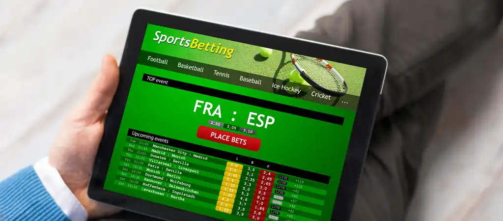 Online sportfogadás egy táblagépen, élő fogadási lehetőségek futball, tenisz, jégkorong és egyéb sportágakban.